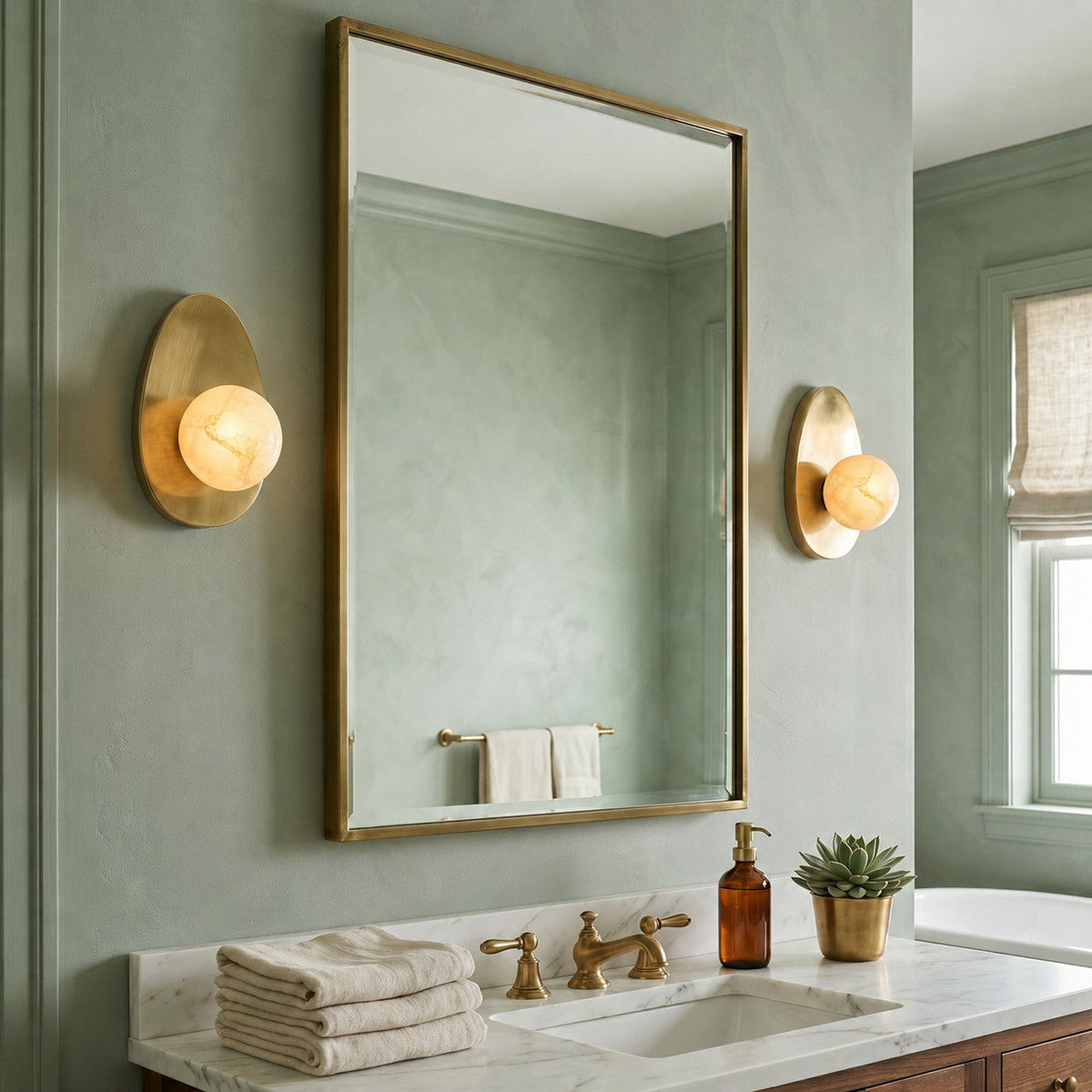 Orba Alabaster Wall Sconce — product setting and fixture profile, a round stone shade on a brass wall mount (view 2)