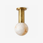 Pestle globe ceiling light with a spherical shade and brass-finish column