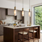 Santorini Alabaster Pendant Lamp — product setting and fixture profile, a cylindrical stone shade with slim brass hardware (view 2)