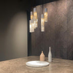 Silo Alabaster Pendant Light — product setting and fixture profile, cylindrical stone shades suspended at different levels (view 2)
