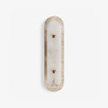 Travertine Pill Sconce — full fixture profile, a pill-shaped travertine frame surrounding a stone inset (view 1)