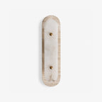 Travertine Pill Sconce — full fixture profile, a pill-shaped travertine frame surrounding a stone inset (view 1)