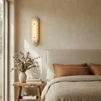 Travertine Pill Sconce — product setting and fixture profile, a pill-shaped travertine frame surrounding a stone inset (view 2)