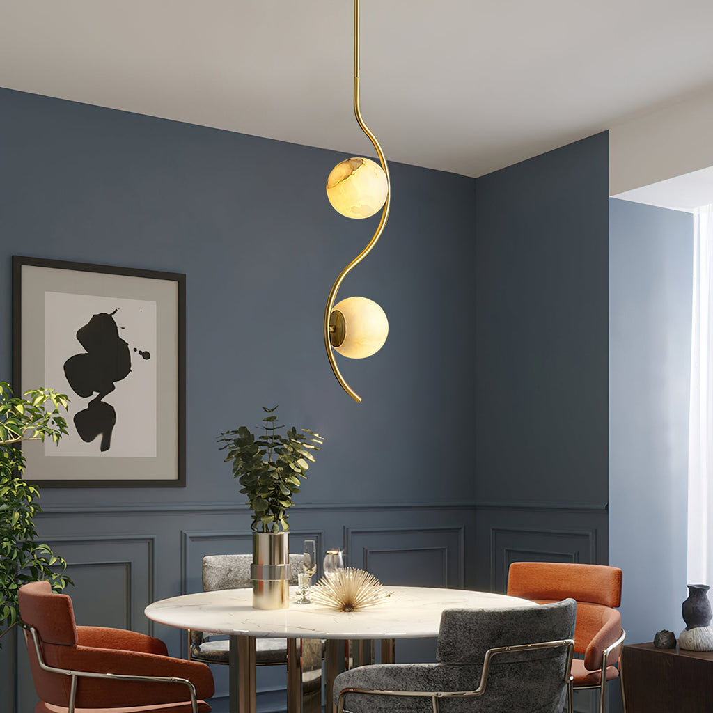 Uva Curved Pendant Lamp — product setting and fixture profile, a stone shade carried by curved brass hardware (view 2)