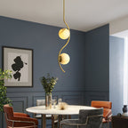 Uva Curved Pendant Lamp — product setting and fixture profile, a stone shade carried by curved brass hardware (view 2)