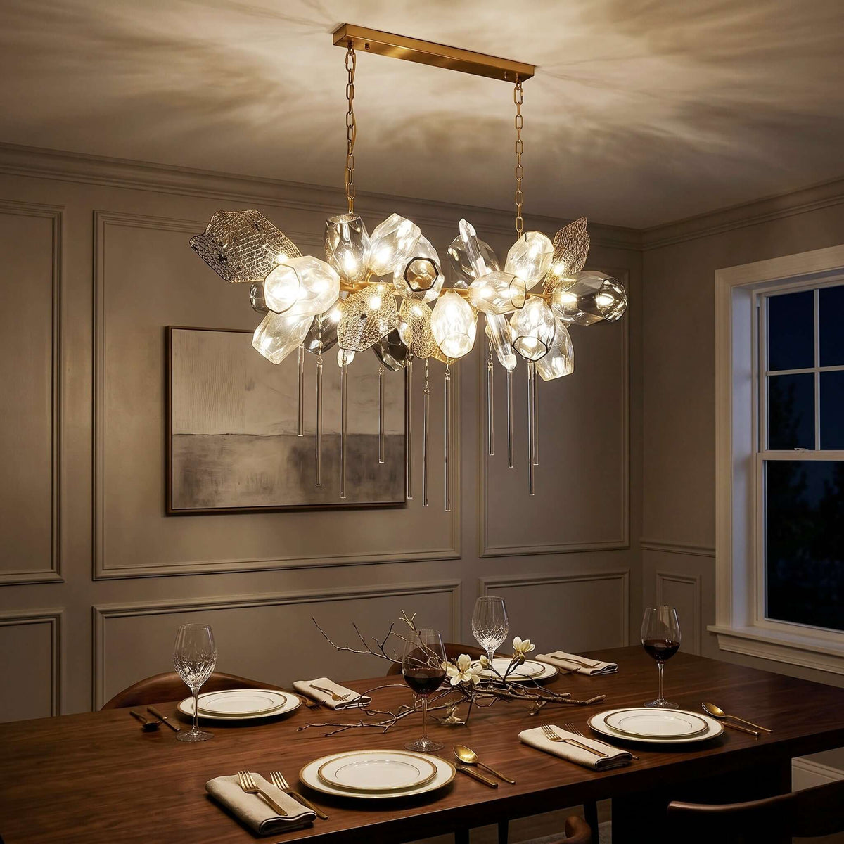 Britannica horizontal chandelier above a dining table at night