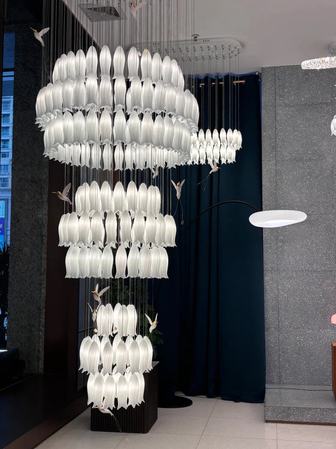 Ceramic Tulip Cascade Staircase Chandelier chandelier in a tall interior