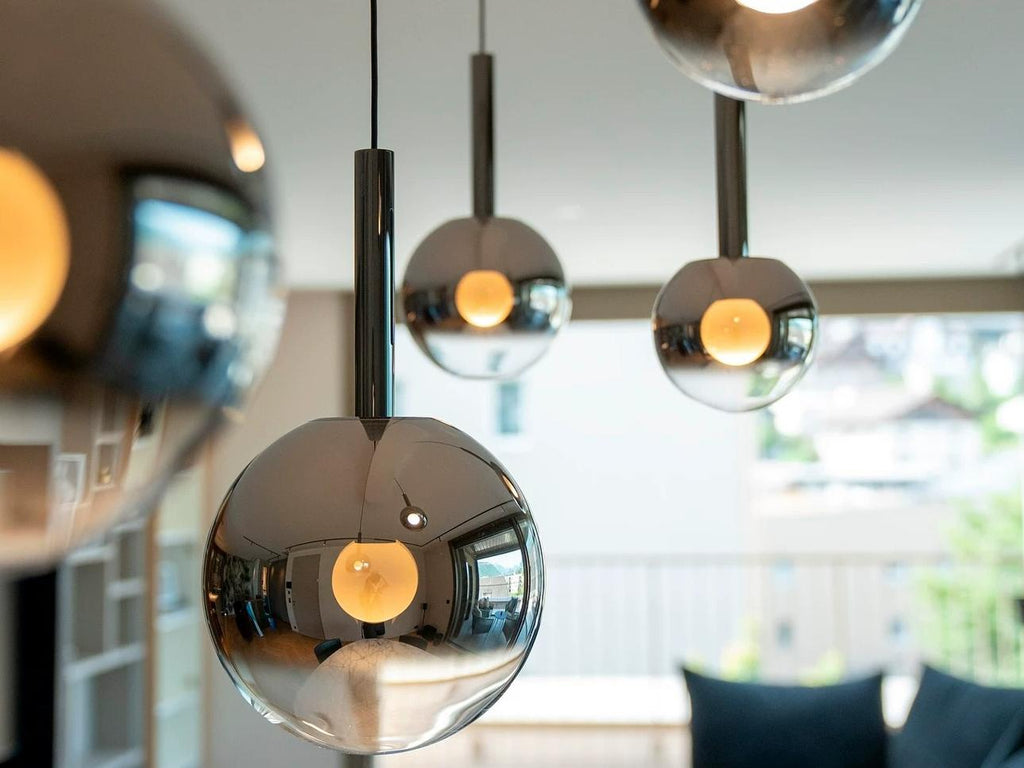 Close up of Cleo Bubble smoke glass globe pendant lights with warm white bulbs