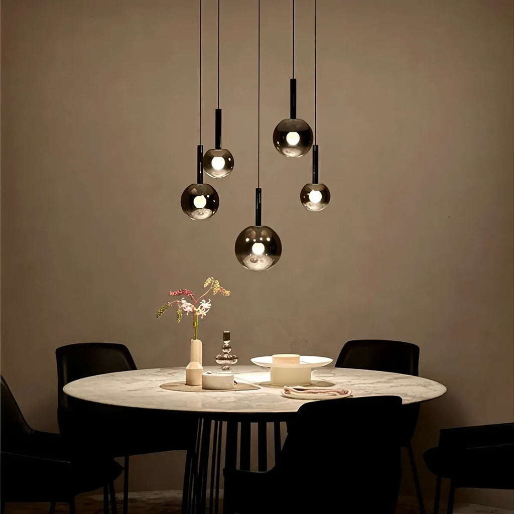 Five light Cleo Bubble Glass Chandelier over a dining table with warm ambient lighting