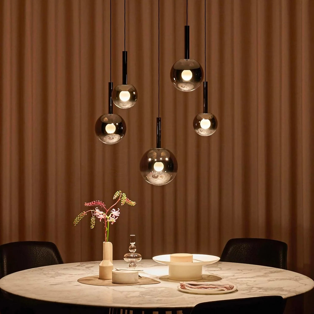 Cleo Bubble Glass Staircase Chandelier with smoke glass globes above a dining table