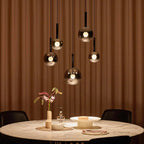 Cleo Bubble Glass Staircase Chandelier with smoke glass globes above a dining table