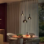 Three light Cleo Bubble smoke glass pendant chandelier above a small dining area