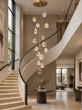 Contemporary LED crystal pendant chandelier with gold canopy in curved staircase