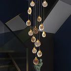 Contemporary LED Chandelier with Crystal Pendant glowing in a dark stairwell with cascading crystal discs and sculpture decor