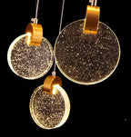 Close-up of Contemporary LED Chandelier with Crystal Pendant showing gold hardware and sparkling crystal disc pendants