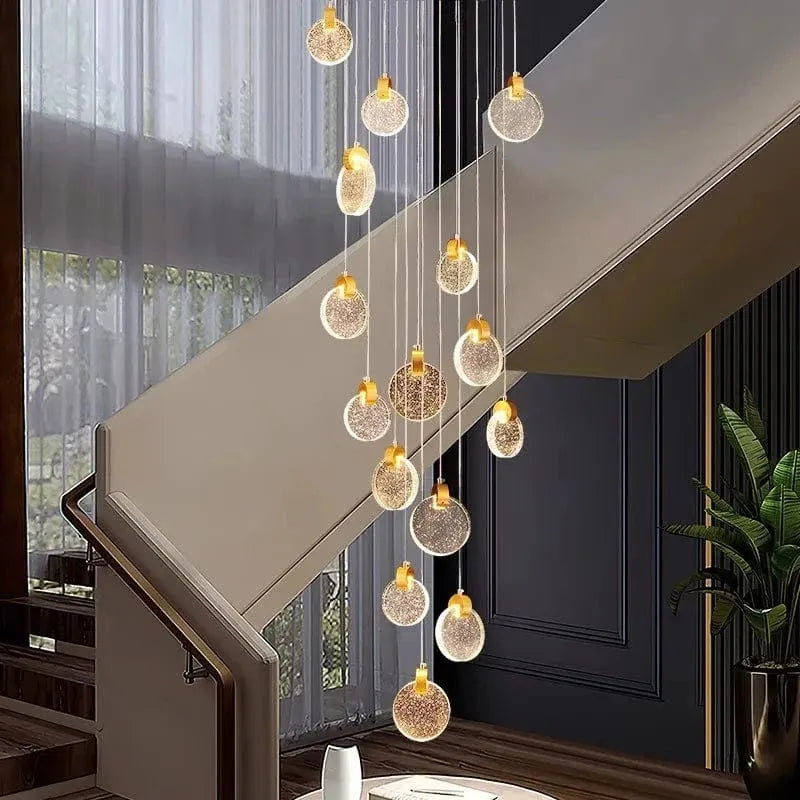 Contemporary LED Chandelier with Crystal Pendant installed beside a staircase with sheer curtains and warm crystal pendants