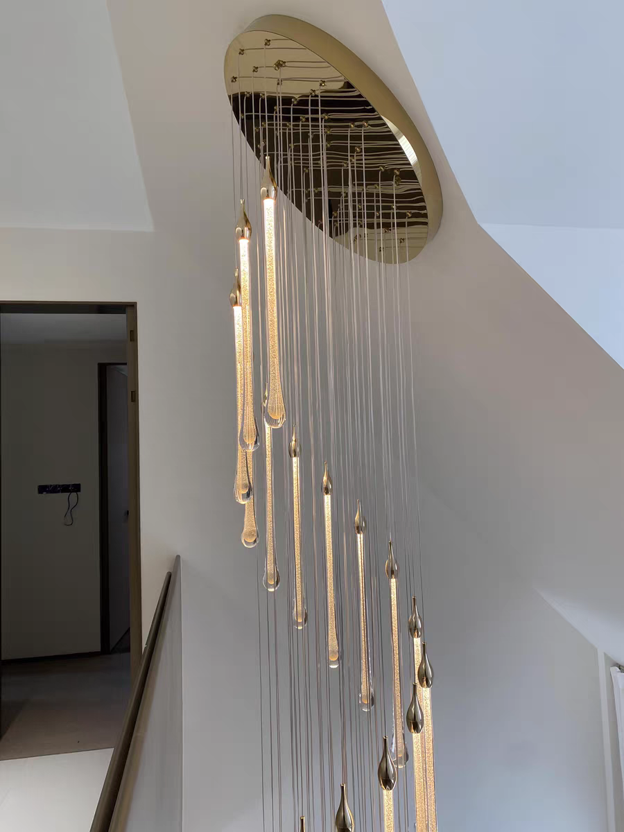 Crystal Raindrop Cascade Staircase Chandelier with polished gold canopy and vertical LED crystal drops