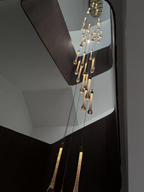 Crystal Raindrop Cascade Staircase Chandelier with staggered clear crystal drops in a tall interior