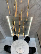 Crystal Raindrop Cascade Chandelier casting patterned light in a tall interior space