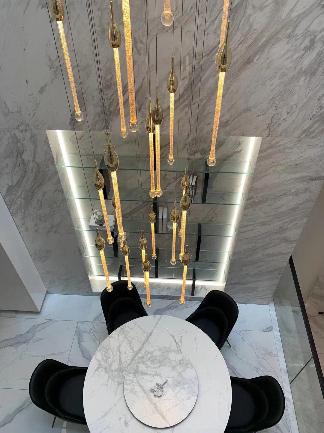 Crystal Raindrop Cascade Chandelier casting patterned light in a tall interior space