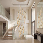 Crystal Raindrop Cascade Staircase Chandelier suspended through a curved stairwell with glass railing