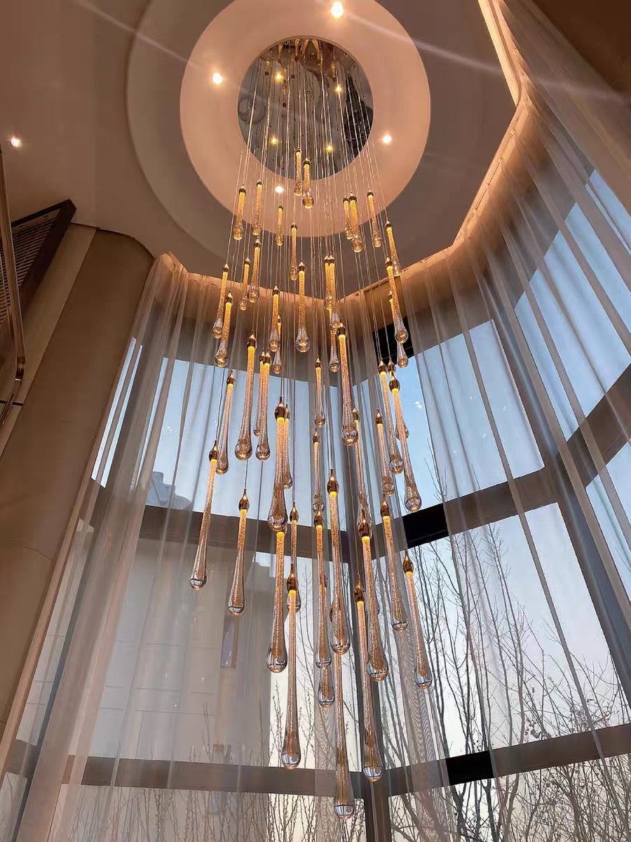 Crystal Raindrop Cascade Staircase Chandelier viewed from below with a round gold canopy and elongated crystal pendants