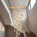 Crystal Raindrop Cascade Staircase Chandelier in a high-ceiling stairwell with gold crystal teardrop pendants