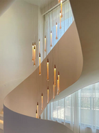 Crystal Raindrop Cascade Chandelier installed in a curved staircase with multiple suspended LED crystal drops