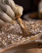 Hand finishing brass and glass detail for Dandelion lighting collection