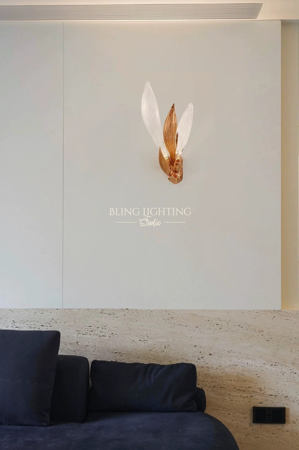 Dandelion glass wall sconce installed above a living room sofa