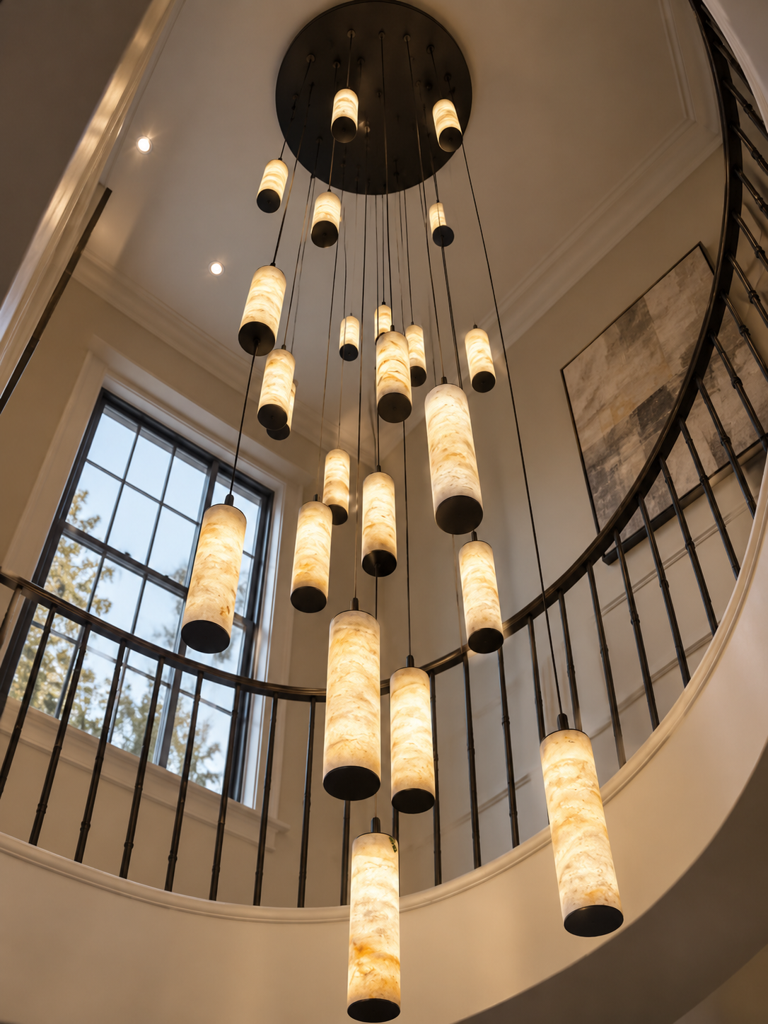 Darlen Alabaster Modern Staircase Chandelier in an entryway with long suspended tube lights