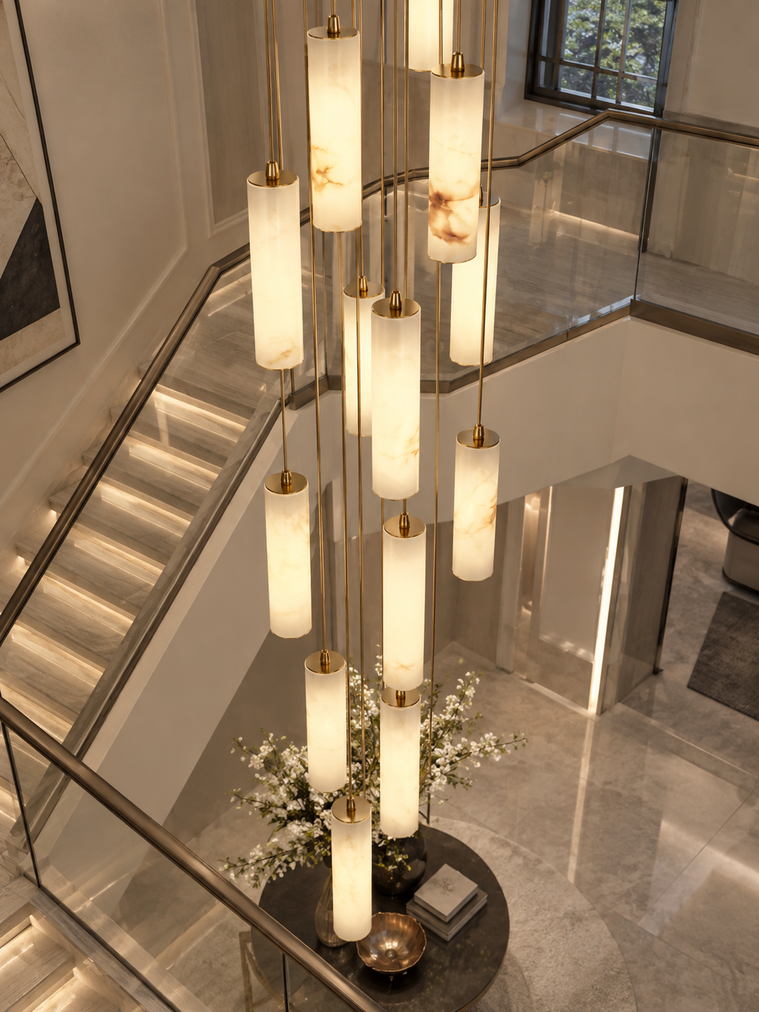 Darlen Alabaster Modern Staircase Chandelier installed in a modern high ceiling stairwell