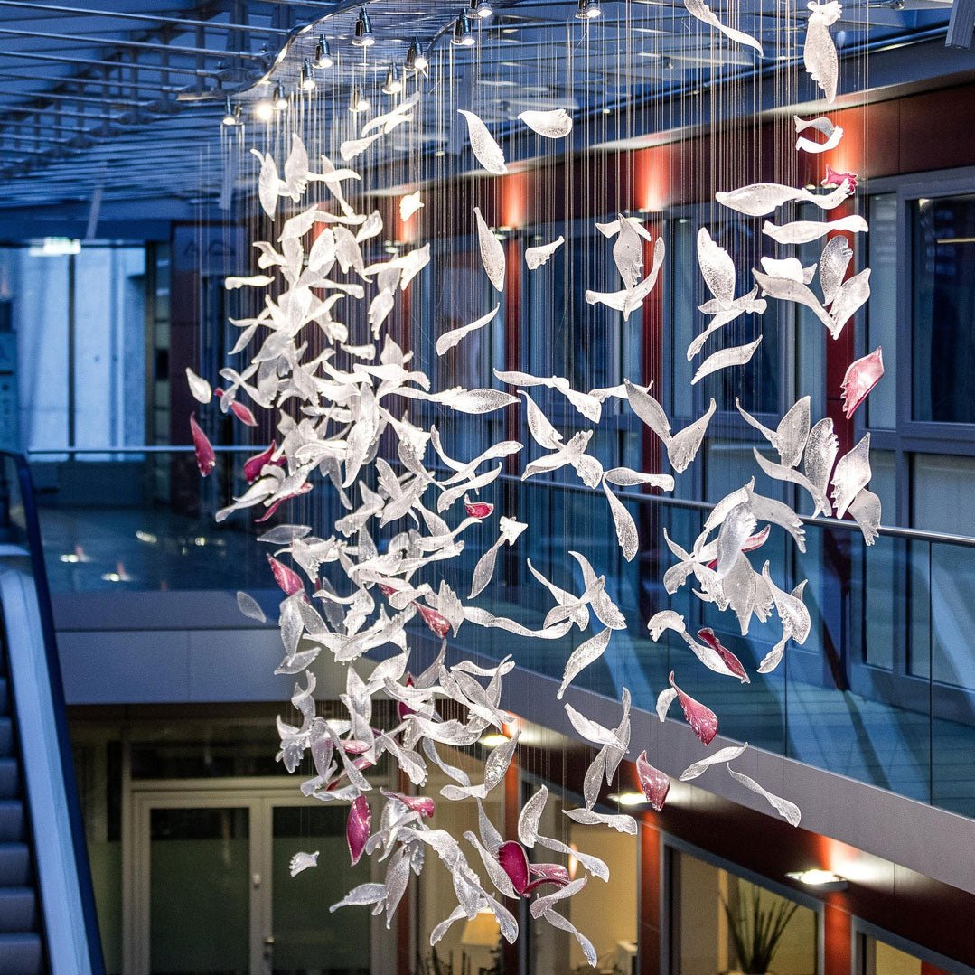 Flying Glass Feather Chandelier chandelier in a tall interior
