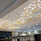 Glass Maple Leaf Hanging Light for Staircase spread across a commercial ceiling with gold and clear glass leaves