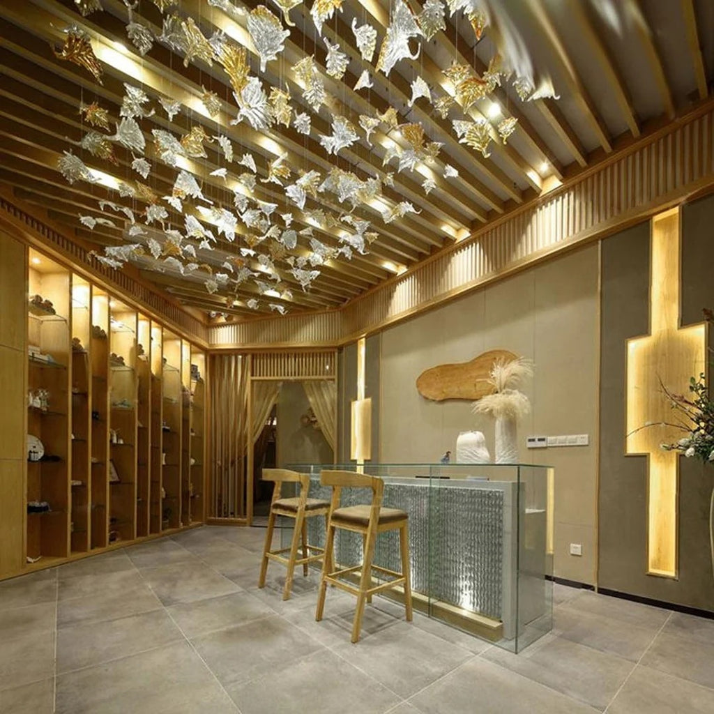 Glass Maple Leaf Hanging Light for Staircase installed over a kitchen bar with a warm wood ceiling