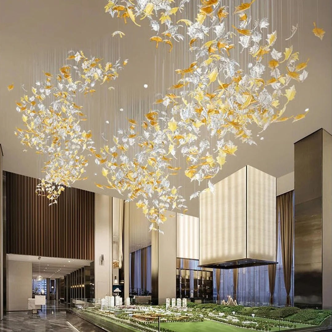 Glass Maple Leaf Hanging Light for Staircase in a lobby entrance at night with glowing glass maple leaves