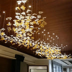Glass Maple Leaf Hanging Light for Staircase in a long ceiling installation with gold and clear leaves