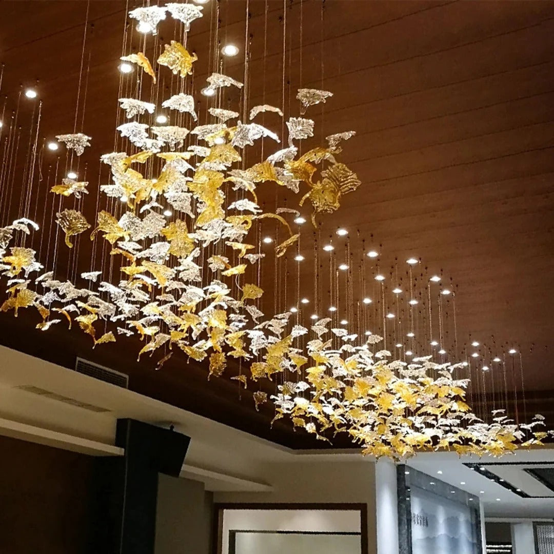 Glass Maple Leaf Hanging Light for Staircase in a long ceiling installation with gold and clear leaves