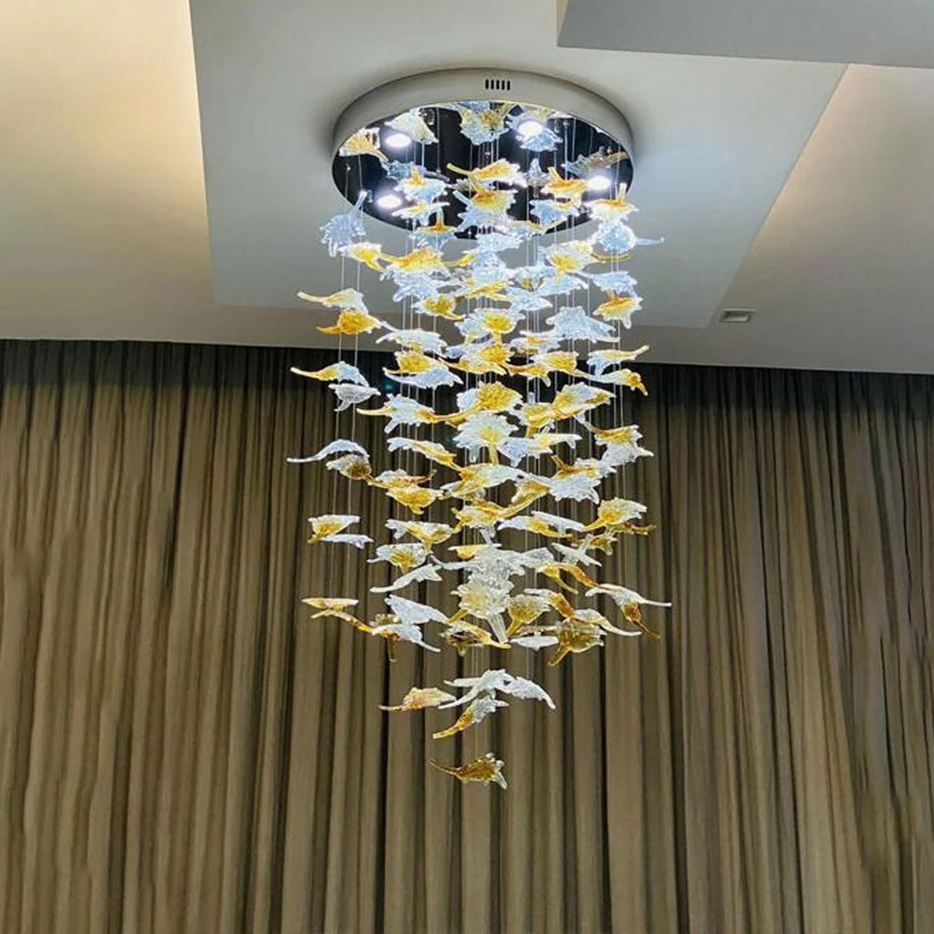 Glass Maple Leaf Hanging Light for Staircase with round canopy and cascading leaves in front of curtains