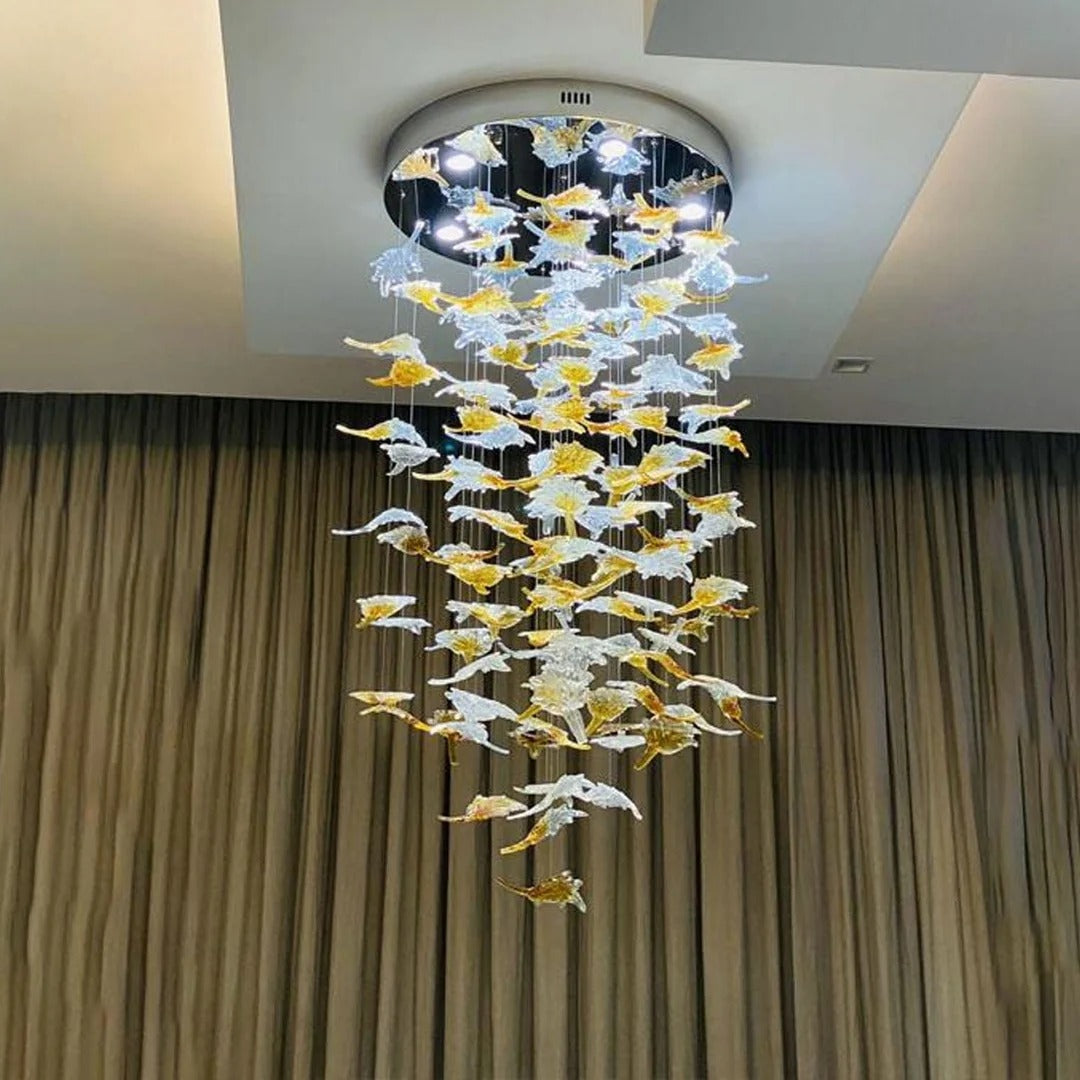 Glass Maple Leaf Hanging Light for Staircase with round canopy and cascading leaves in front of curtains