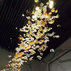 Glass Maple Leaf Hanging Light for Staircase cascading beside a stairwell with illuminated maple leaves