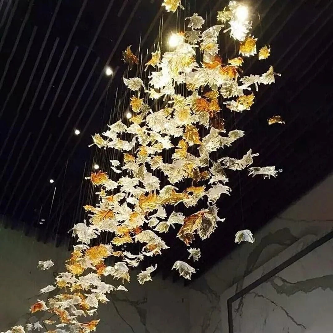 Glass Maple Leaf Hanging Light for Staircase cascading beside a stairwell with illuminated maple leaves