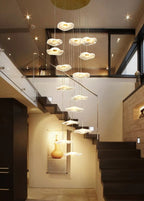 Gold Acrylic Flower Led Chandelier For Stairwell, Staircase installed in a tall entryway beside a modern staircase