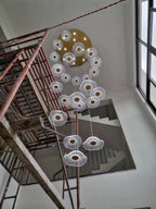 Gold Acrylic Flower Led Chandelier For Stairwell, Staircase shown during high ceiling stairwell installation with multiple flower LED pendants