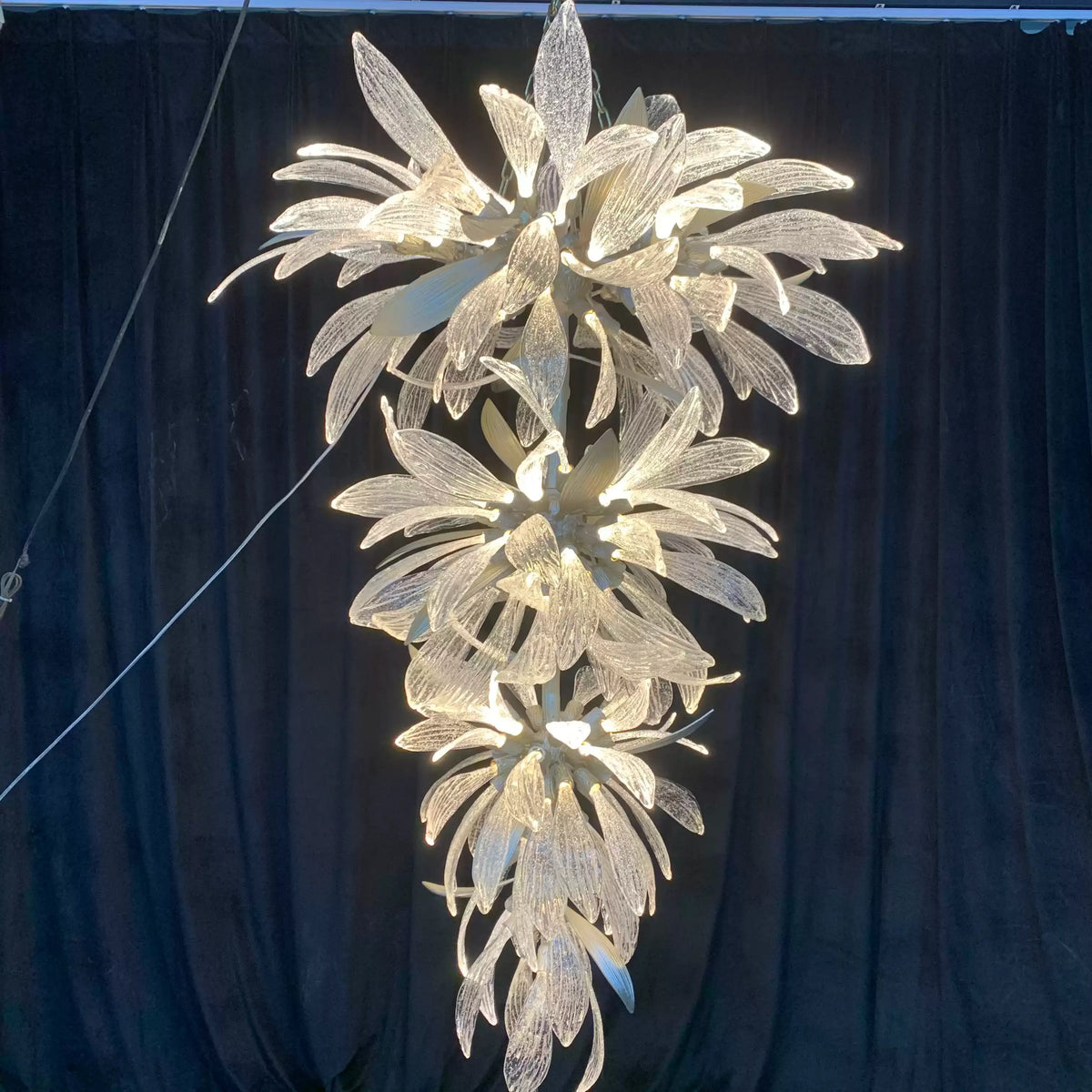 Dandelion Cascade Glass Staircase Chandelier chandelier in a tall interior
