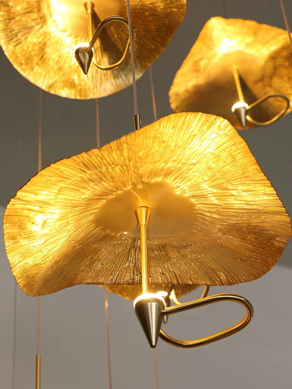 Jenissa Vintage Staircase Chandelier warm light close-up of layered gold lotus leaf shades