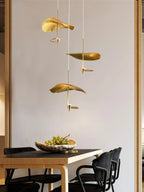 Jenissa Vintage Staircase Chandelier with gold lotus leaf pendants above a dining table