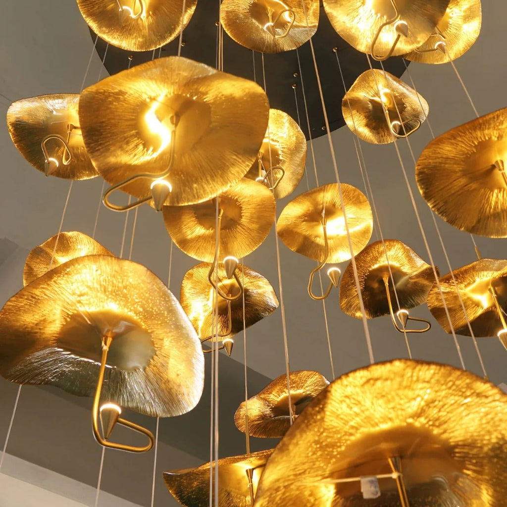 Jenissa Vintage Staircase Chandelier close-up of gold lotus leaf shades and warm textured finish