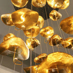 Jenissa Vintage Staircase Chandelier close-up of gold lotus leaf shades and warm textured finish