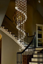 Large Foyer Lighting For High Ceiling and Entryway installed by a curved staircase with cascading crystal strands